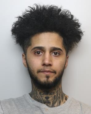 mugshot of a man with long dark hair and dark facial hair