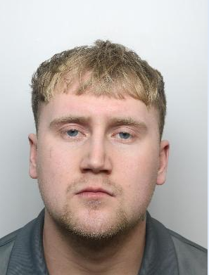 Mugshot of a man with blond hair