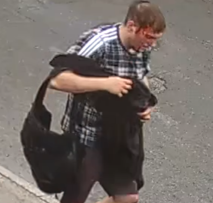 CCTV image of a man carrying a bag