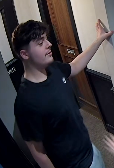 CCTV image of a white man wearing a black tshirt