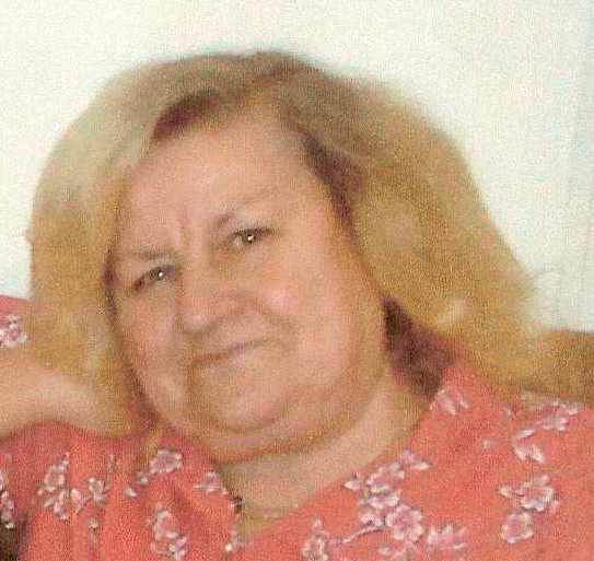 image of a blonde woman wearing a pink top