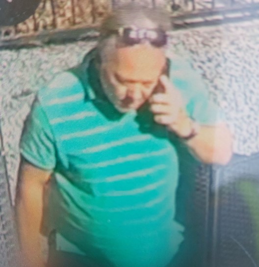 A man in a stripy top talks on the phone