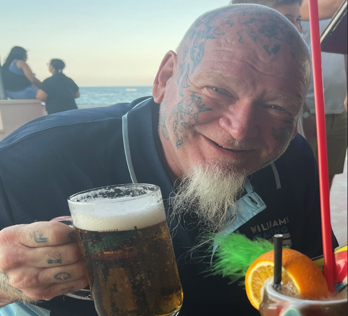 image of a man holding a beer
