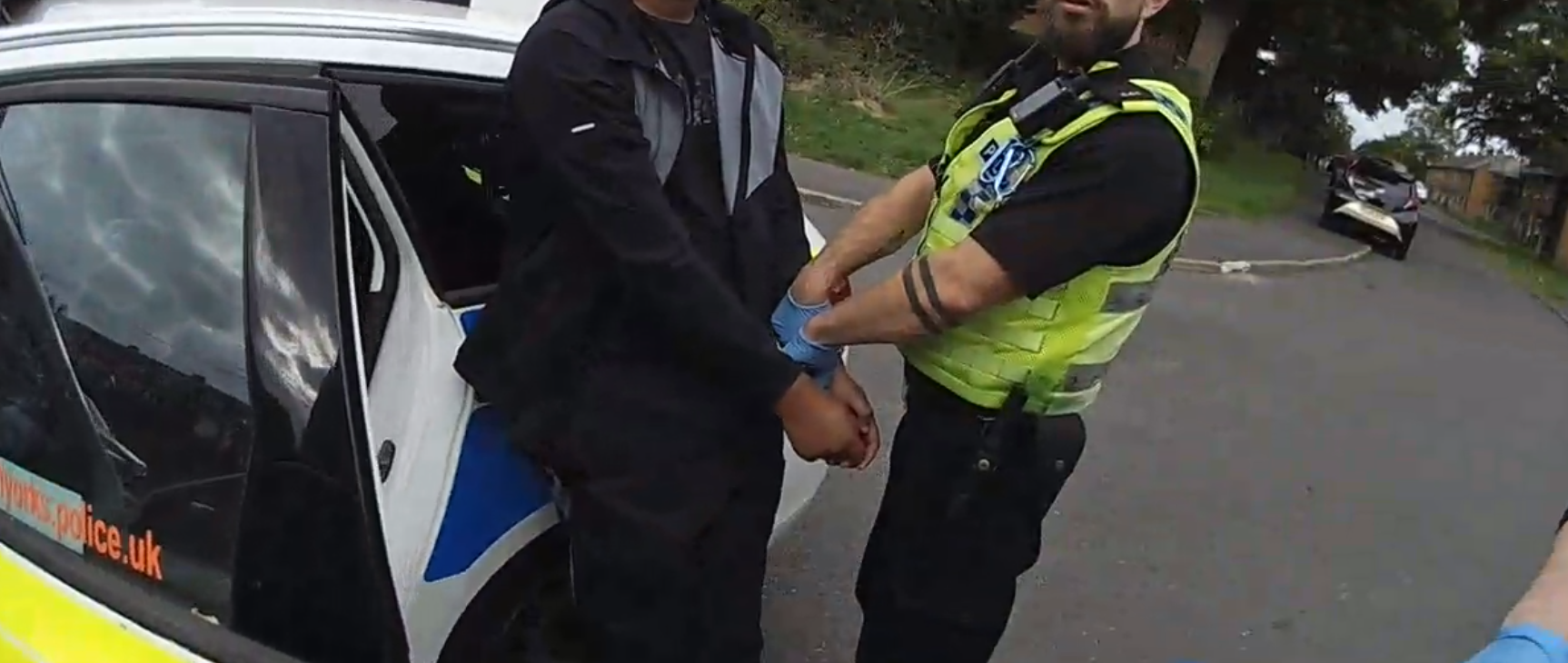 Image of boy being arrested by police officer