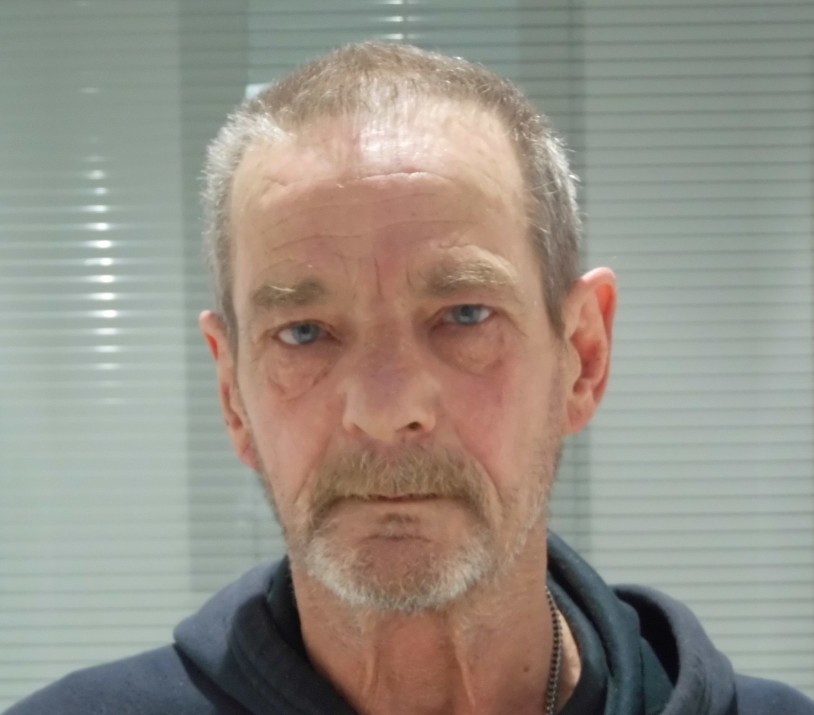 Raymond Utley is a white man with short balding hair and facial hair. He is standing in front of a white background for a custody picture