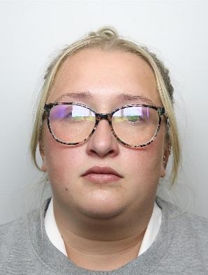 Custody image of a white woman with blonde hair scraped back wearing glasses