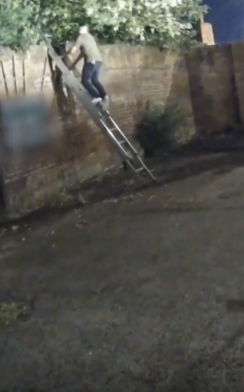 A police negotiator climbs a ladder as he speaks to a burglary suspect prior to his arrest