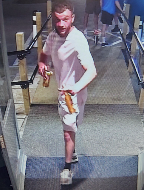 An image of a man standing wearing with shorts 