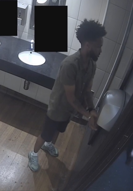 Man in dark shorts and a t-shirt.