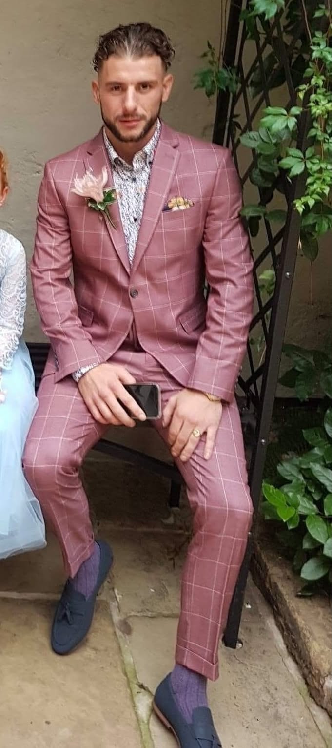 A man wearing a pink suit