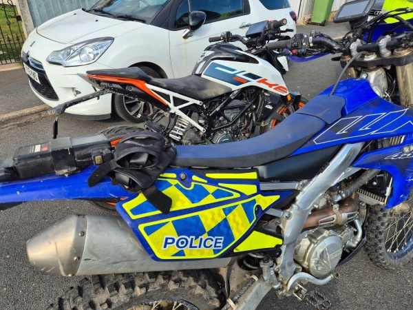 A police bike next to an off road bike 