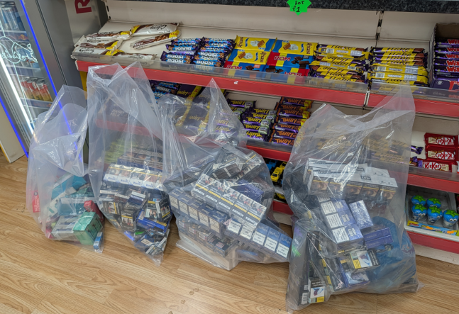 seized vapes and cigarettes in clear bags