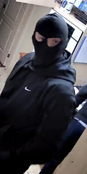 CCTV image of man wearing a black balaclava and a black Nike jacket