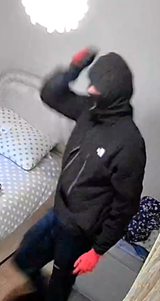 CCTV image of man wearing a black balaclava, red gloves and North Face jacket