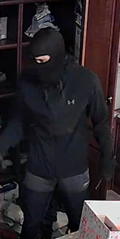 CCTV image of man wearing a black balaclava, black Under Armour jacket