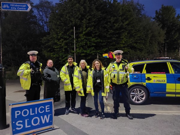 An image of polcie officers standing with council representatives in high vis clothing 